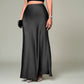 Lavishly Me Riviera black satin maxi skirt with a fluid, floor-length silhouette worn with heels and a clutch.