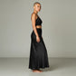 Model wearing a Lavishly Me black satin maxi skirt with a matching crop top in a minimalist studio setting.