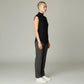 Model wearing a black Lavishly Me sleeveless turtleneck top with grey tailored trousers and white sneakers