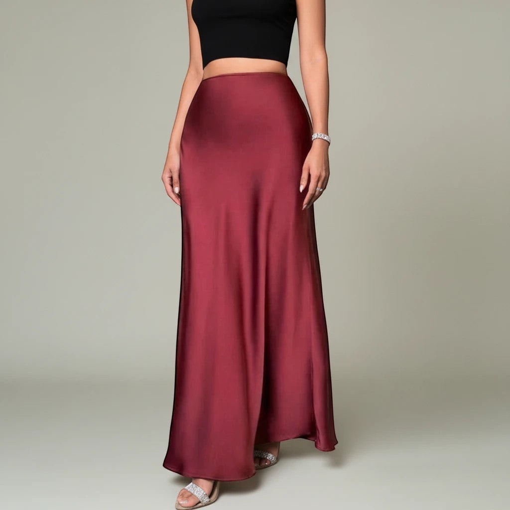 Lavishly Me Riviera satin maxi skirt in deep burgundy with a flowing silhouette worn with a black crop top