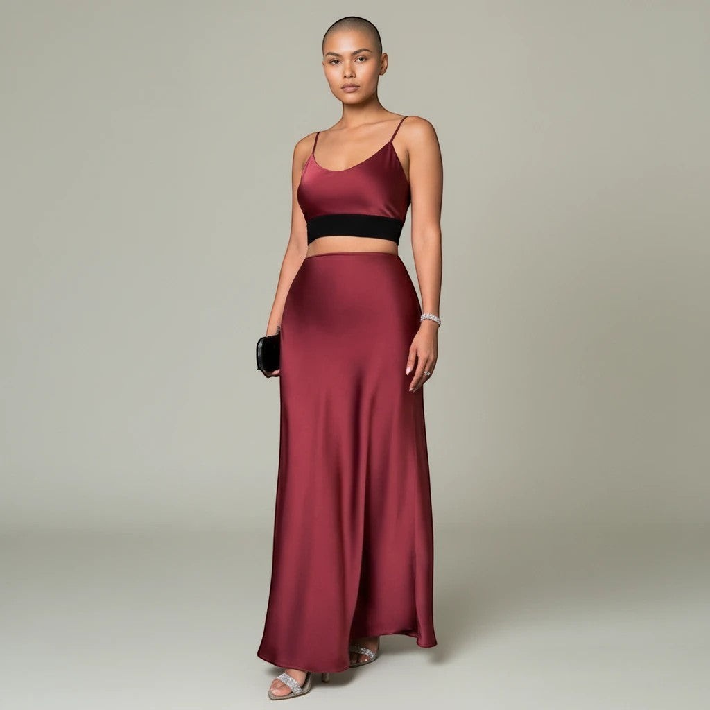 Model wearing a Lavishly Me burgundy satin maxi skirt and matching crop top with a fluid, elegant silhouette.