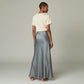 Model wearing a Lavishly Me grey satin maxi skirt with a beige t-shirt, viewed from the back.