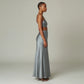 A model wearing a Lavishly Me grey satin maxi skirt and matching crop top, viewed from the side in a studio setting.