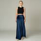 Model wearing a Lavishly Me navy blue satin maxi skirt with a black sleeveless crop top against a neutral background.
