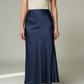 Lavishly Me navy blue satin maxi skirt with a fluid, minimalist silhouette worn with a cream top.