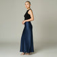 Model wearing a Lavishly Me navy blue satin maxi skirt with a black sleeveless top and metallic heels