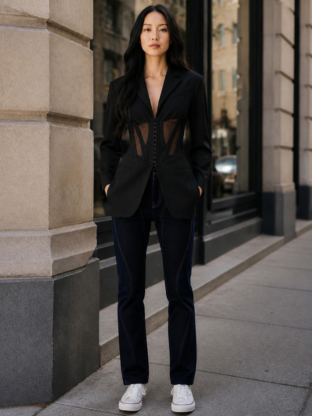 Model wearing Lavishly Me black Nocturne mesh blazer with sheer corset-style panels and notched collar on city street