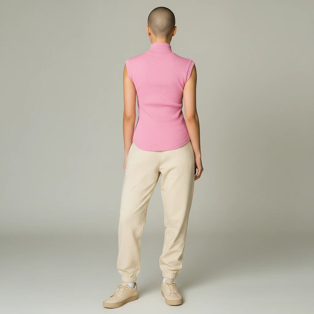 Lavishly Me Sloane sleeveless pink ribbed turtleneck top worn with beige joggers, back view