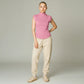 Model wearing a pink Lavishly Me sleeveless turtleneck top with beige joggers and sneakers