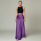 Model wearing a Lavishly Me purple satin maxi skirt with a black sleeveless crop top against a neutral background.