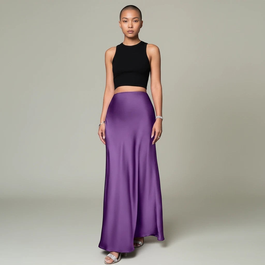 Model wearing a Lavishly Me purple satin maxi skirt with a black sleeveless crop top against a neutral background.