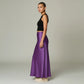 Model wearing a Lavishly Me purple satin maxi skirt with a black sleeveless crop top, side profile view.