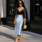 Lavishly Me Valencia satin fishtail skirt in light blue worn with a black crop top and leather jacket on a city street